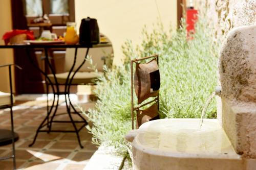 a fountain in the middle of a patio with a table at Elaia-Fos in Rhodes Town