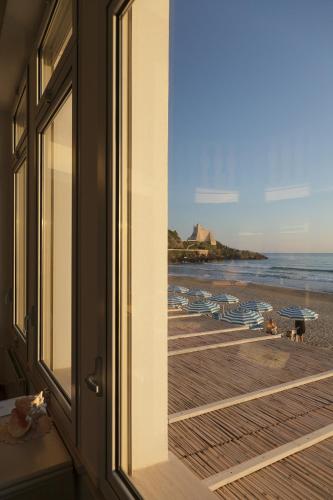 a view of the beach from a room with a window at Hotel Aurora in Sperlonga