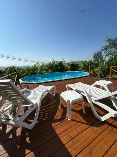 a deck with two lounge chairs and a swimming pool at Casa Das Vendas in Vendas
