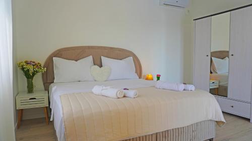 a bedroom with a bed with two towels on it at Villa AntiMar in Međugorje