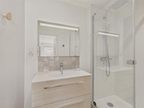 a white bathroom with a sink and a shower at 300 m de la plage - Appart pour 4 avec balcon in Beg-Meil