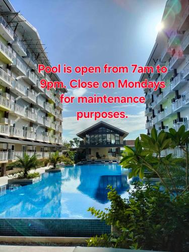 a resort pool is open from to at Pool View Room 333B Amani Grand Resort near Mactan Cebu Airport Free wifi, netflix, pool and gym house, 3mins to airport in Pusok