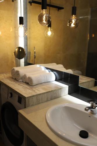 a bathroom with a sink and a washing machine at Puerto Duquesa fancy condo overlooking Marina in Manilva