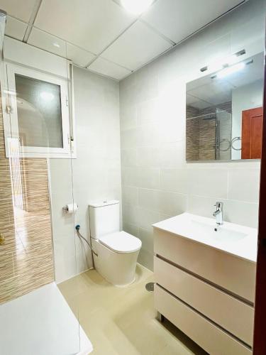 a bathroom with a toilet and a sink at Villa Ensueño with private pool and large garden in Mazarrón