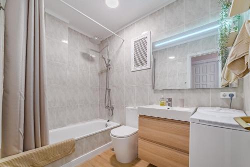 a bathroom with a tub and a toilet and a sink at Stunning cliffs and ocean view in Los Gigantes in Acantilado de los Gigantes