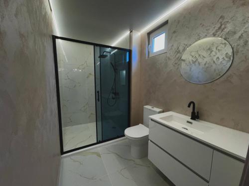 a bathroom with a shower and a toilet and a sink at Seagull Apartments in Byala