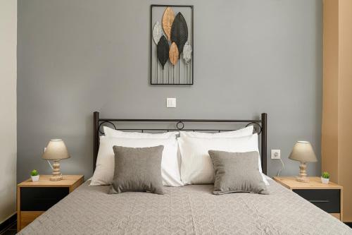 a bedroom with a large bed with two lamps on tables at Petros & Eirini Home in Zarós