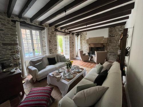 a living room with a couch and a table at Chambres d'hôtes de charme au cœur de Tréguier in Tréguier