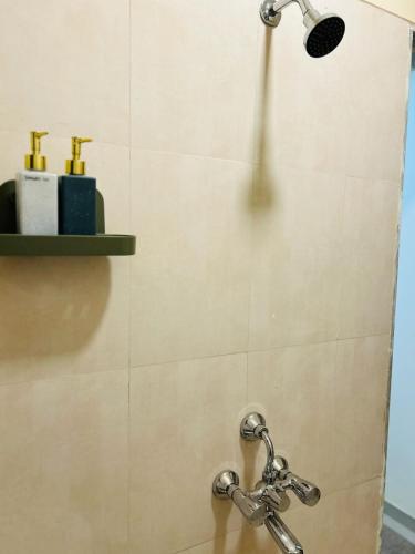 a shower with a shower head in a bathroom at Sky Escape, Cloud-Level Living in Thane