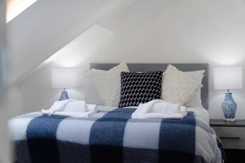 a bedroom with a blue and white bed with towels on it at Spacious! 6BR in Beach Road in South Shields