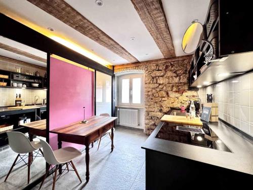 a kitchen with a wooden table and some chairs at Villa Schloss Rimsingen Fine Apartments in Breisach am Rhein