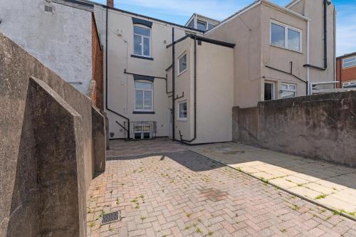 an empty parking lot in front of a building at Spacious! 6BR in Beach Road in South Shields