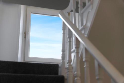 a stairway with a window and a stair case at Spacious! 6BR in Beach Road in South Shields