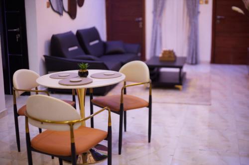 a living room with a table and chairs at LuxSafe Haven Lagos in Lekki