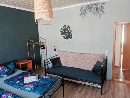 a living room with two beds and a couch at SaxonyBNB in Waldheim