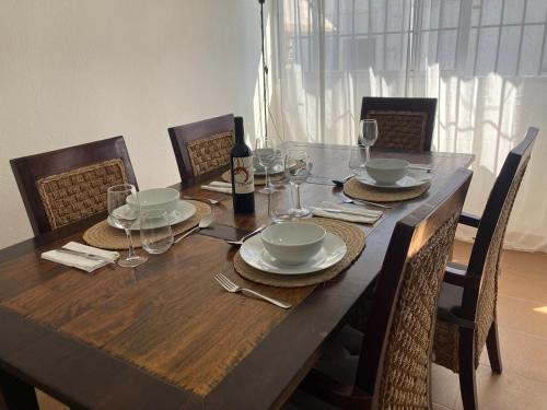 a wooden table with glasses and a bottle of wine at Apartamento Socorro in Ronda
