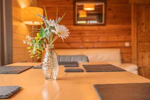 a vase of flowers sitting on top of a table at Lodge 1 in Stirling