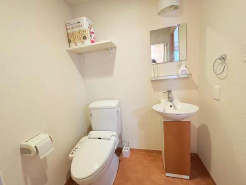 a bathroom with a white toilet and a sink at ARSTAy池袋62 in Tokyo