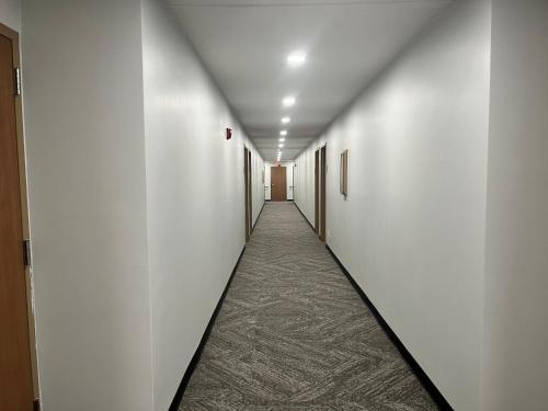 a hallway with white walls and a long corridor at Studio 6 Ogden, UT 21st Street in Ogden