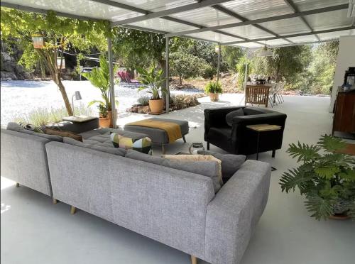 a living room with couches and a patio at Casa Rocas Private Pool with swimjet! in Comares