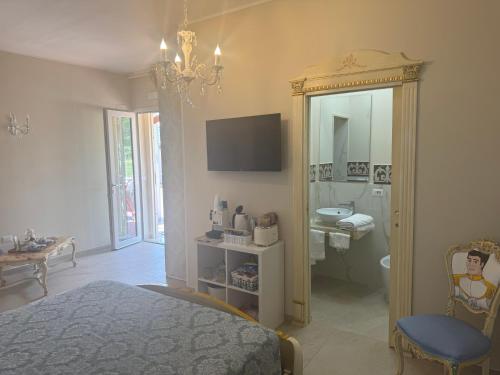 a bedroom with a bed and a bathroom with a mirror at B&b Villa Romano in Salerno