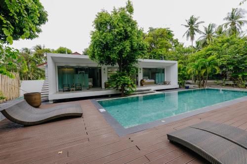 a swimming pool in front of a house at KPG Suite Dream in Ban Nua
