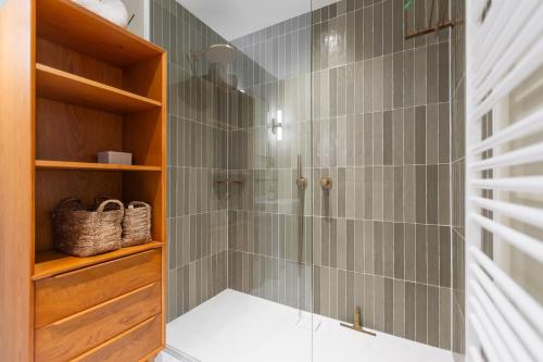 a shower with a glass door in a bathroom at Central Heaven in Ostend