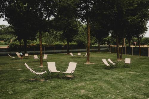 a group of chairs sitting in the grass at Ca' Nadin Agriturismo in San Damiano dʼAsti