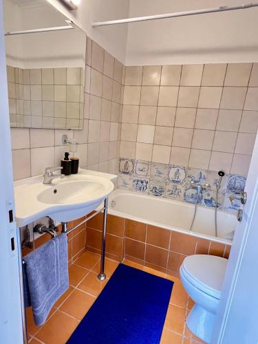 a bathroom with a sink and a tub and a toilet at Mountain View Apartment Lefkada in Apolpaina