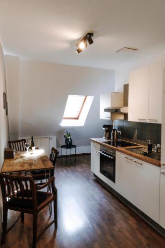 a kitchen and dining room with a table and chairs at Ferienwohnungen am Holstentor in Lübeck