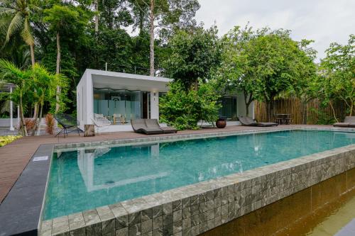 a swimming pool in front of a house at KPG Suite Dream in Ban Nua