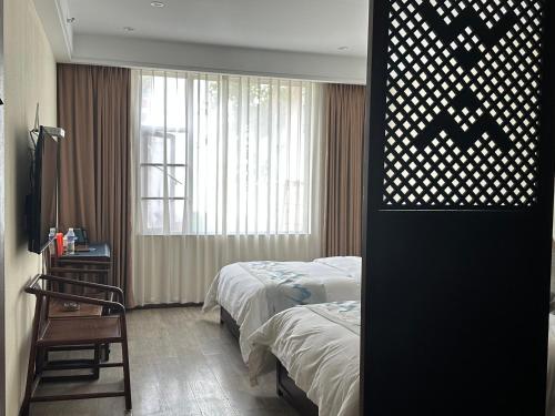 Xinwei Hotelにあるベッド