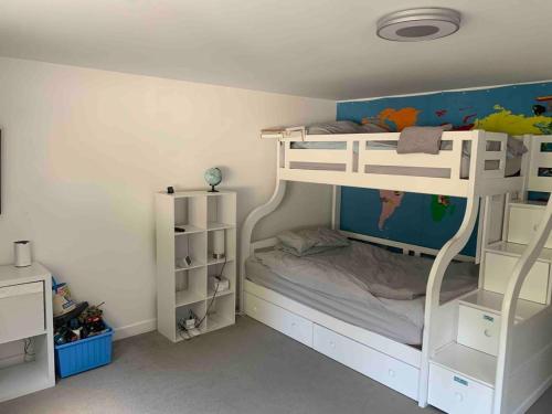 a childs bedroom with a bunk bed and shelves at Featured on Channel 4 with George Clarke with lazy spa in Bournemouth