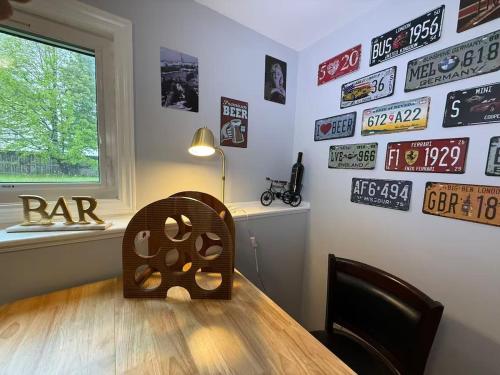 a room with a table and signs on the wall at Tranquil Riverside Abode in Cornwall