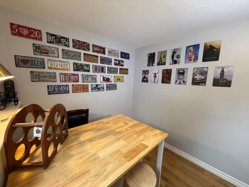 a dining room with a wooden table and pictures on the wall at Tranquil Riverside Abode in Cornwall