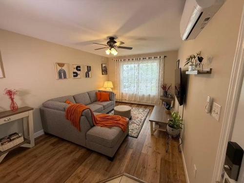 a living room with a couch and a ceiling fan at Tranquil Riverside Abode in Cornwall