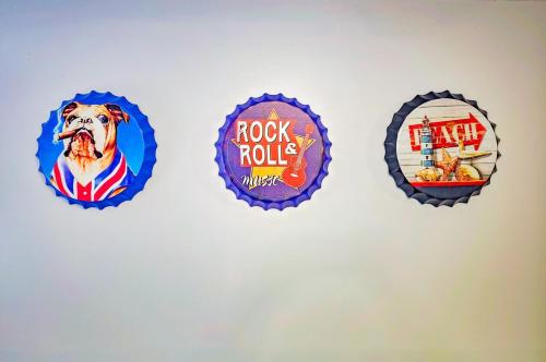 four badges on a wall with a dog on it at Tranquil Riverside Abode in Cornwall