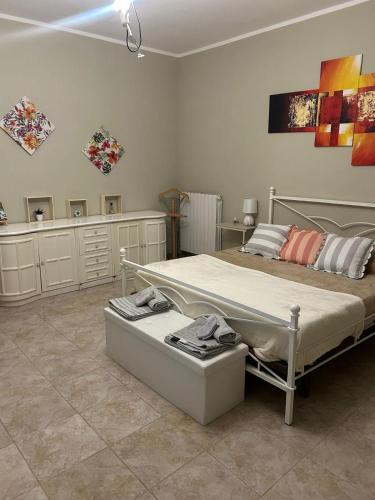 a bedroom with a large bed and some pictures on the wall at IL Lago dei sogni in Posta Fibreno