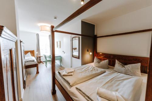 a bedroom with a large bed with a wooden frame at Ferienwohnungen am Holstentor in Lübeck
