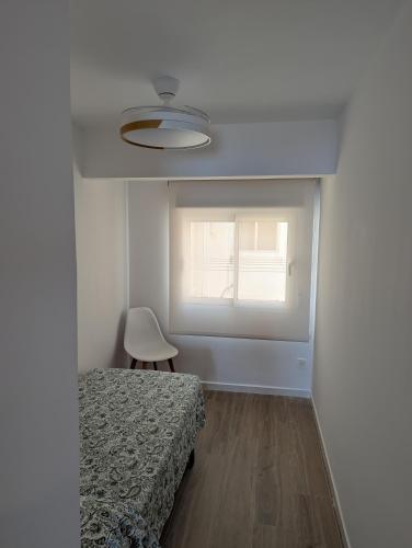 a bedroom with a bed and a window at Apartamento en Primera Línea in Cullera
