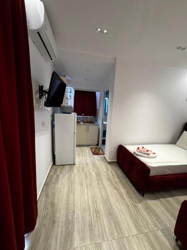 a small room with a bed and a refrigerator at Vila ZOGAJ in Ksamil