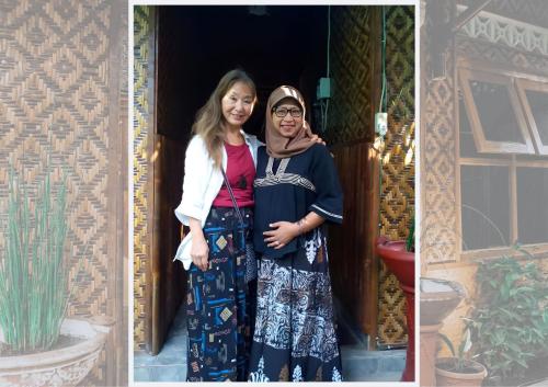 two women standing in a doorway of a house at Glory Homestay in Yogyakarta