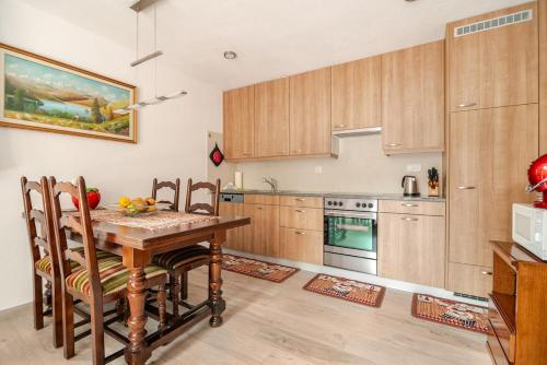 a kitchen with a wooden table and chairs in a room at Casa Flora in Gordola