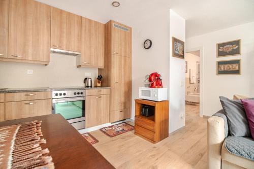 a kitchen with a couch and a table in a room at Casa Flora in Gordola