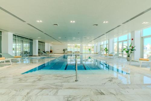 a large swimming pool in a large building at Cleopatra Sidi Heneish in Marsa Matruh