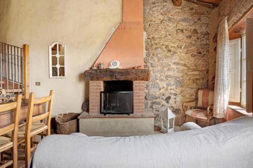 a bedroom with a stone wall with a fireplace at Villa Chelucci - Gualdo in Massarosa