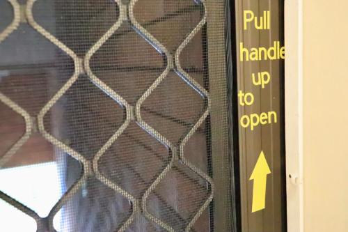 a sign on a door with a wire fence at Jayla's By The Marina in Batemans Bay