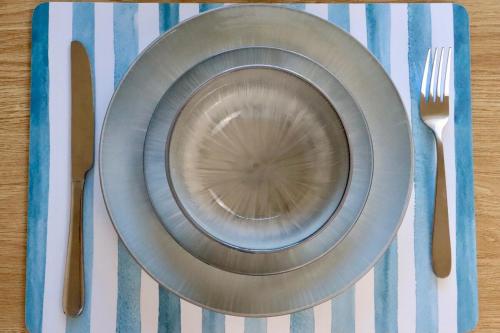 a plate on a table with a fork and knife at Jayla's By The Marina in Batemans Bay