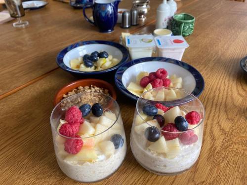 a table with three bowls of fruit in containers at Old Schoolhouse B and B in Enniskillen