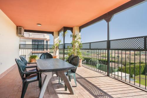 a patio with a table and chairs on a balcony at Camaleón 7 in Chipiona